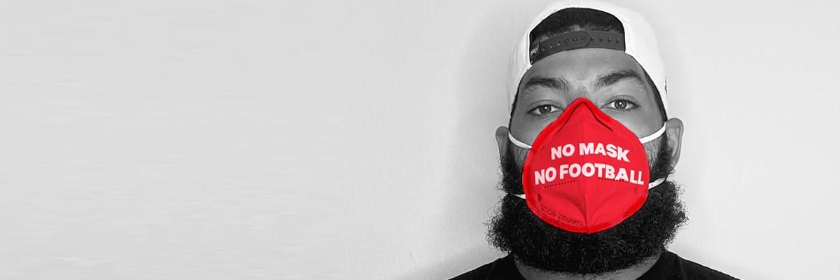 Man wearing a mask that says "No Mask No Football"