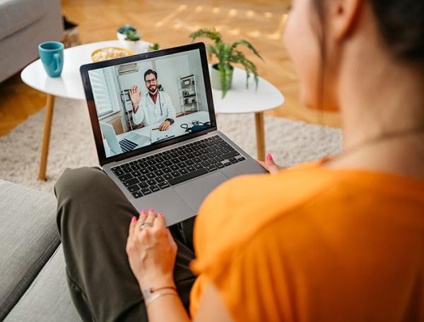 Telehealth image of woman talking to a doctor on her laptop