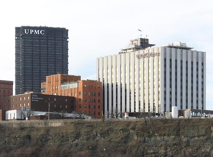 Shot of UPMC Mercy medical campus with UPMC tower in backroud on the left and UPMC Mercy in the foreground on the right
