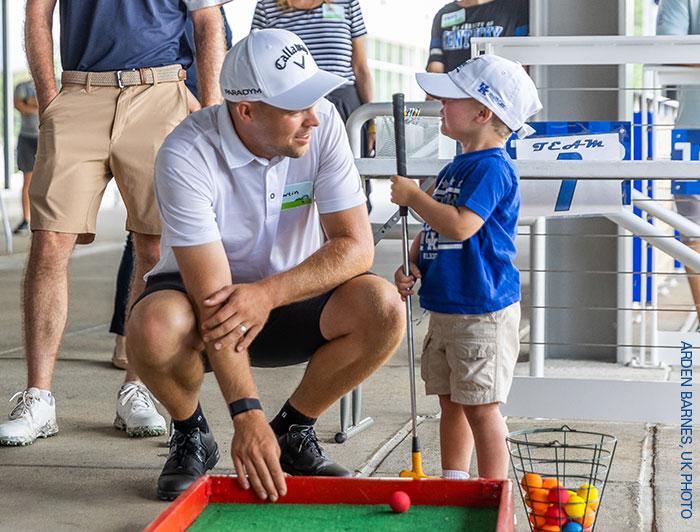 A Kentucky Children's patient and a golfer at the Mini Pro-Am tournament