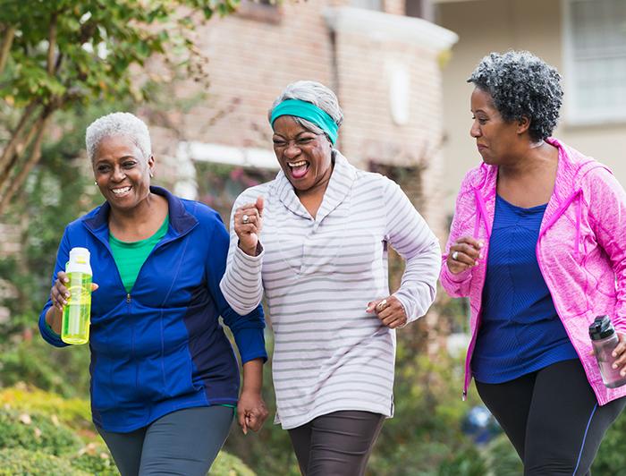 older women shown outdoors in a walking club