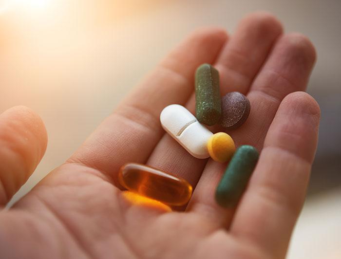 stock image of an open palm holding pills