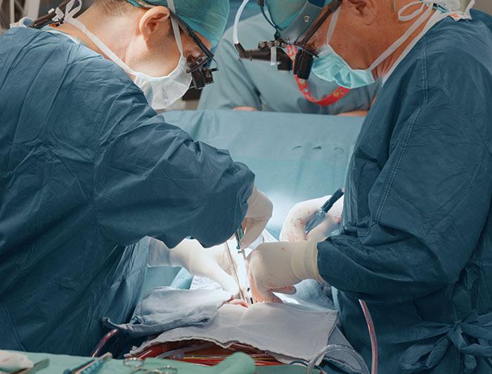 Stock photo pf surgeons in operating on a covered patient