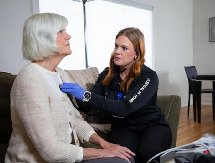 Idaho’s First Hospital-at-Home Program Showing Promising Results. A paramedic listens to a women's heartbeat using a stethoscope as part of hospital-at-home care in Idaho.
