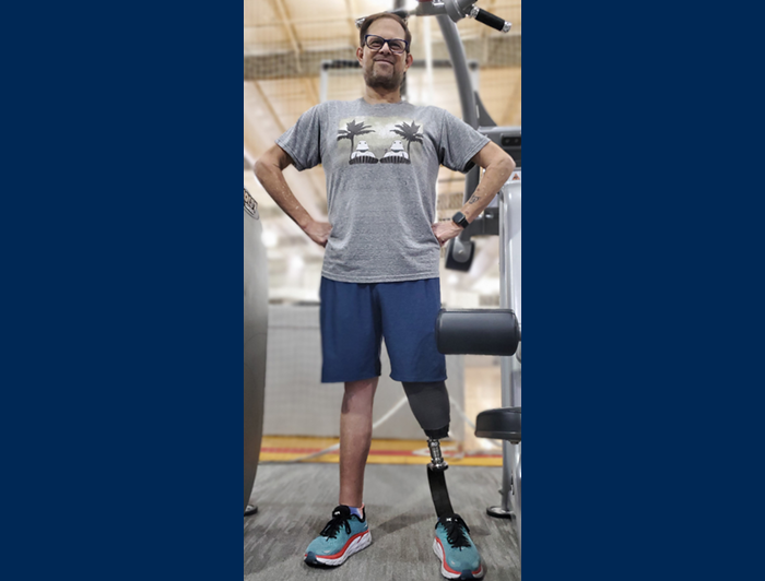 Bobby Watkins stands in a gym, smiling proudly.