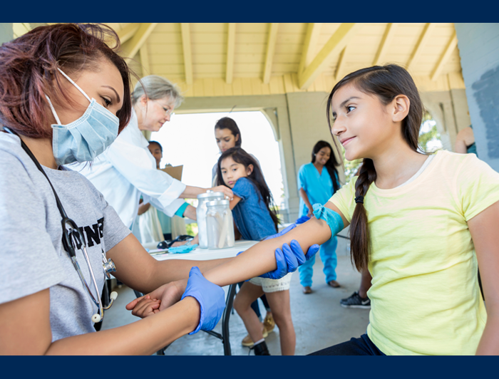 A young girl meets with a health worker at a mobile clinic